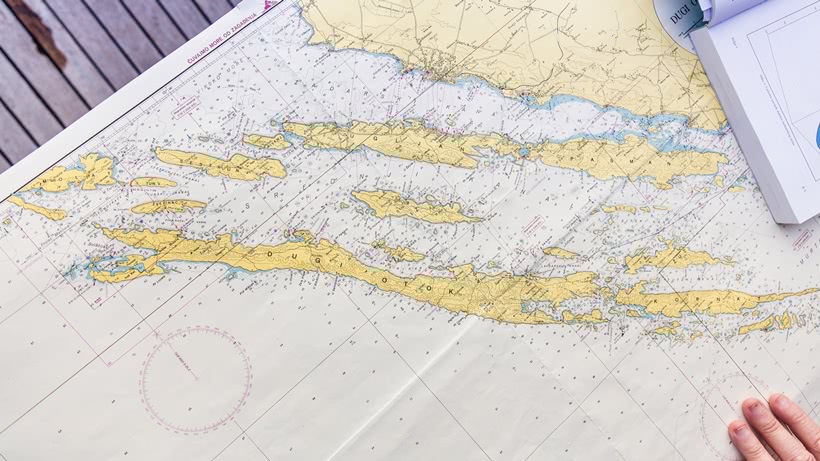 The chart of the Kvarner Bay is spread out on the table