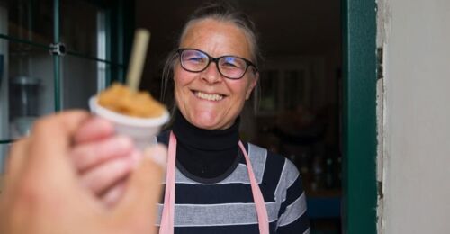 Woman holding a small punnet of ice-cream