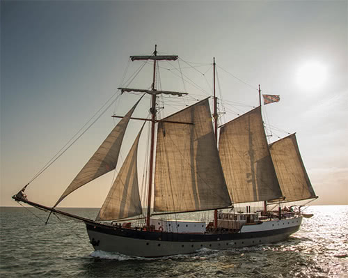 Tall ship Leafde fan Fryslan with sails set in the evening light