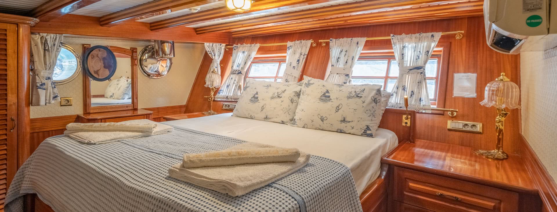 Bed in cabin on board the Admiral with clean folded towels