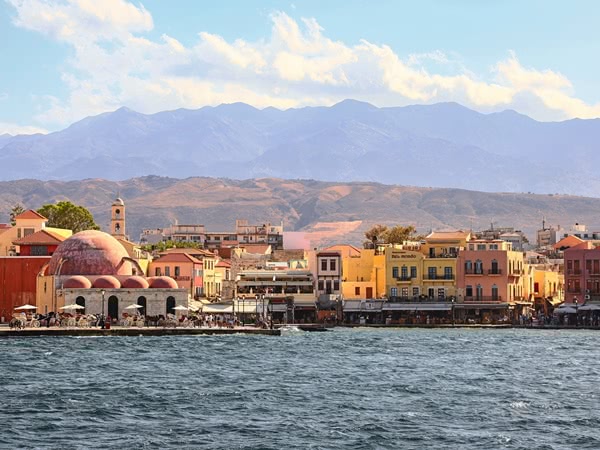 View over sea and Chania harbour with mountains in the background