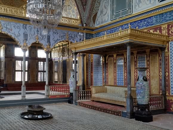 Interior of Topkapi Palace with walls of bright blue, red and gold
