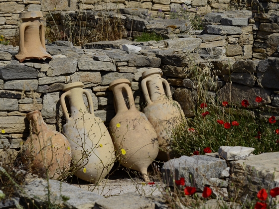 Ancient clay jugs leaning against a brick wall