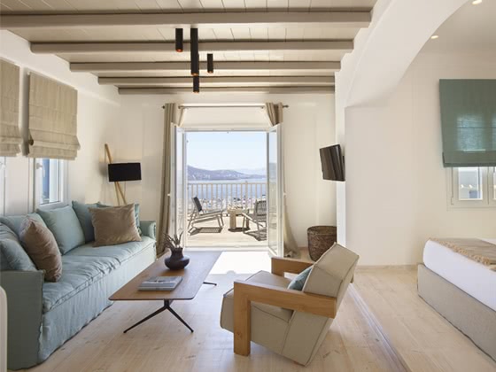 Hotelzimmer mit Sofas, Balkon und Blick auf das Meer