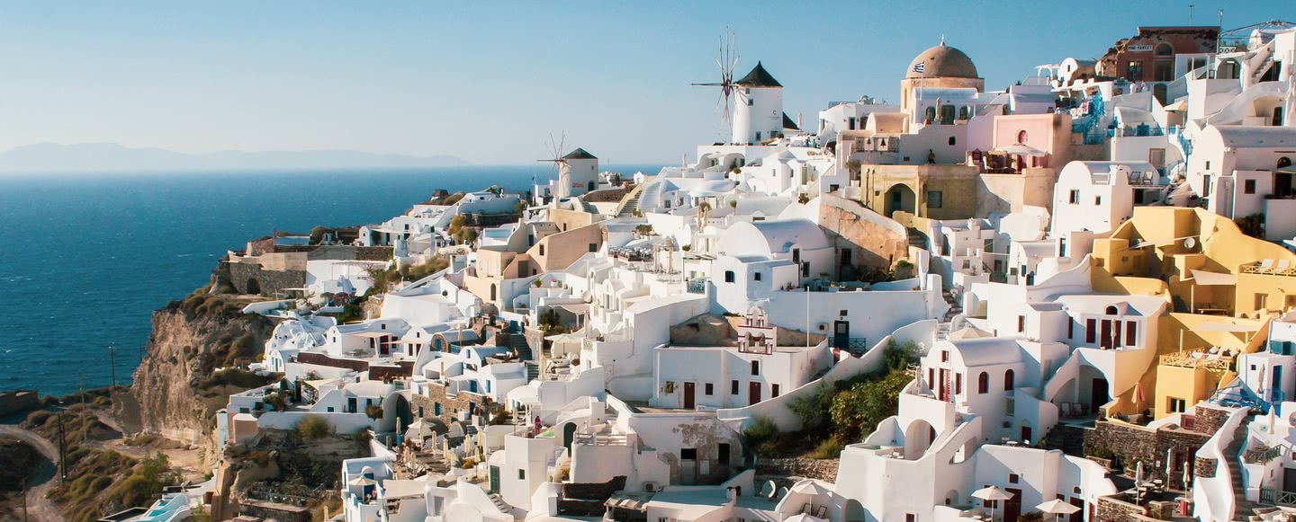 Aerial view over the white and pastel houses of Oia village on Santorini