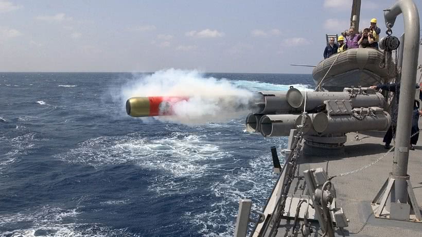 Torpedo being shot from a military ship
